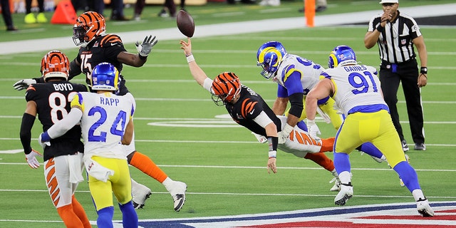 Joe Burrow #9 of the Cincinnati Bengals is fired by Aaron Donald #99 of the Los Angeles Rams in the fourth quarter during Super Bowl LVI at SoFi Stadium on February 13, 2022 in Inglewood, California.