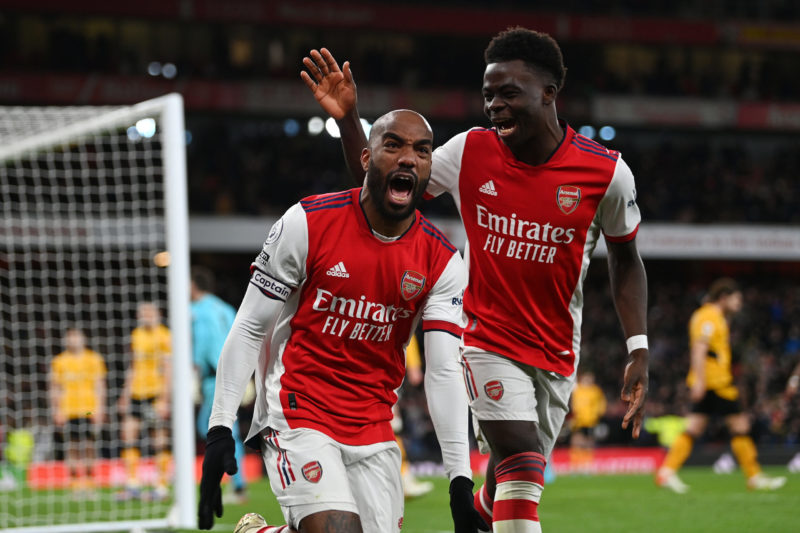 LONDON, ENGLAND - FEBRUARY 24: Arsenal's Alexandre Lacazette celebrates his team's second goal with teammate Bukayo Saka during the Premier League match between Arsenal and Wolverhampton Wanderers at the Emirates Stadium on February 24, 2022 in London, England.  (Photo by Sean Pottrell/Getty Images)