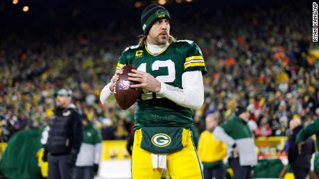 Rodgers throws a pass on the touchline before an NFL playoff against the San Francisco 49ers.