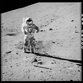 Gene Cernan collects a sample as part of the Apollo 17 . mission