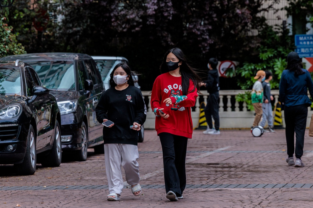 People walk through a residential community under lockdown in Shanghai, China, April 23, 2022.