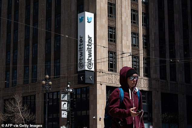 A person walks past Twitter headquarters on April 26, 2022 in downtown San Francisco