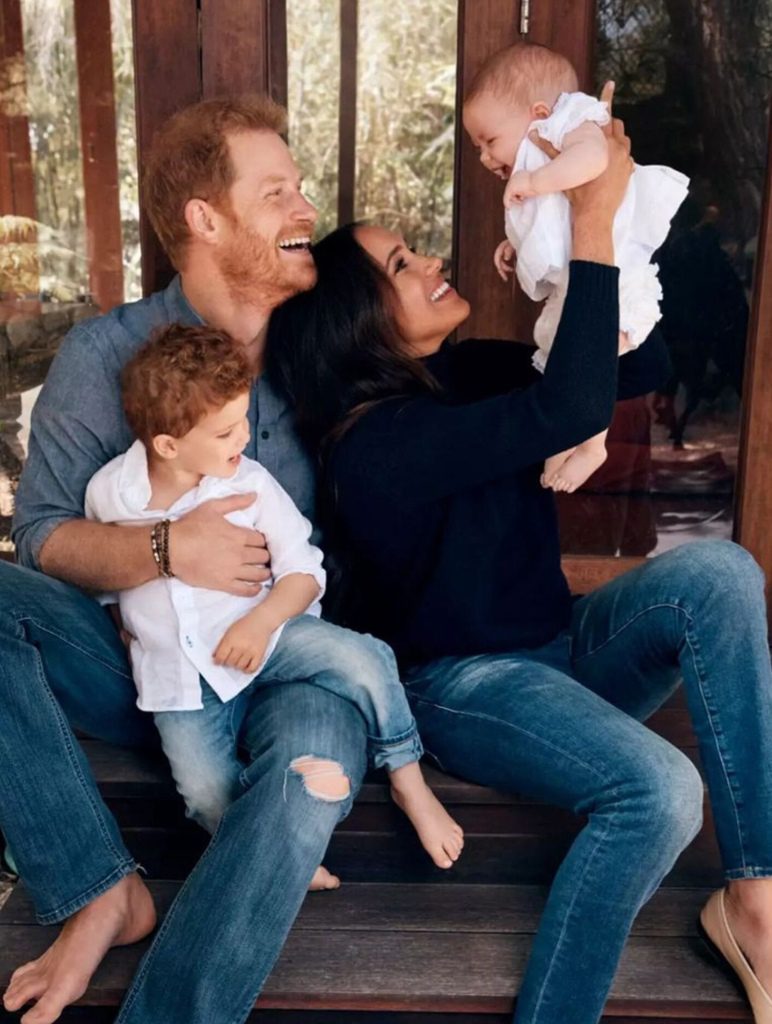 The Christmas photo is only the second photo the couple has released of their daughter after she appeared on the family's Christmas card last year.  Older brother Archie is seen on Harry's lap. 