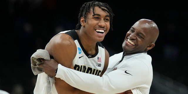 Jaden Ivey #23 of Purdue Boilermakers celebrates with assistant coach Terry Johnson after defeating the Texas Longhorns 81-71 in the second round of the 2022 NCAA Men's Basketball Tournament at the Fiserv Forum on March 20, 2022 in Milwaukee, Wisconsin.