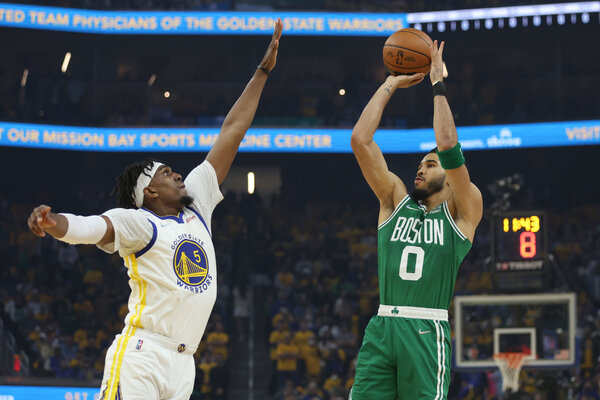 Golden State’s Kevon Looney tries to defend a shot by Boston’s Jayson Tatum.