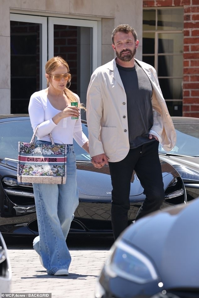New ride: Ben Affleck, 49, and Jennifer Lopez cut cute and casual characters as they browse luxury cars at a store in Beverly Hills on Saturday