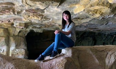 Nina Hong sitting in a rocky crevice