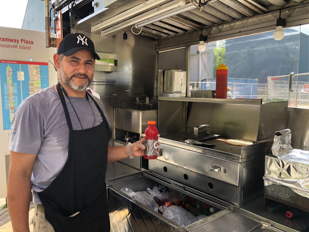 Muhammad Afifi began selling regularly near the information booth on Roosevelt Island this summer.  The booth says it's killing their business.