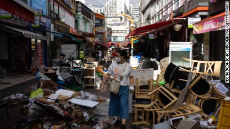 Debris piles up in front of flood-affected shops at Namsung Sagi Market in Seoul, South Korea, on August 10.