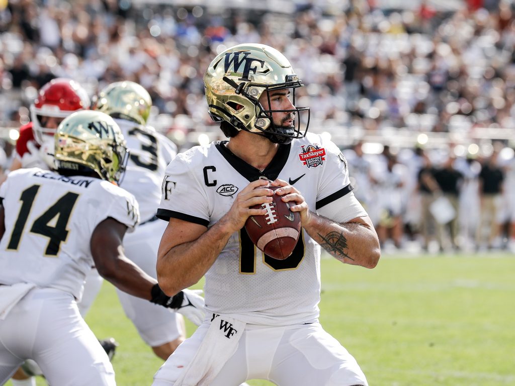 Sam Hartman steps back to pass Wake Forest