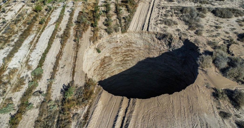 Experts are investigating a mysterious 200-foot-deep crater near a copper mine in Chile