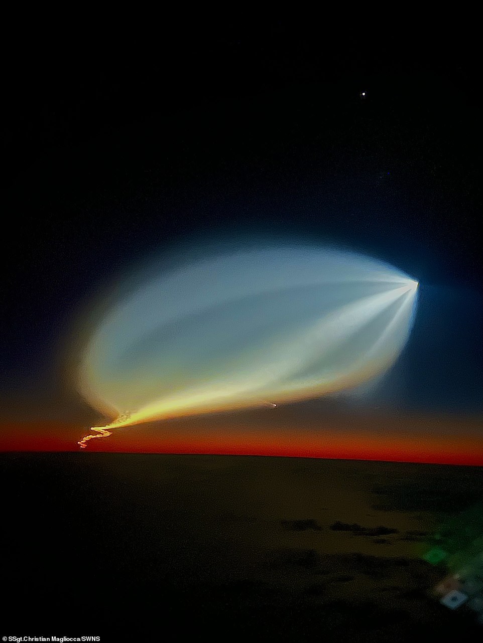 Brilliant: It may have a strange, UFO-like appearance, but the blossoming of light in the sky is actually part of the fallout from the SpaceX rocket launch