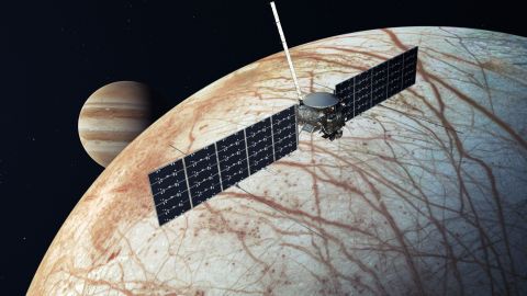 This illustration shows Europa Clipper after it reaches the icy moon, with Jupiter in the background.