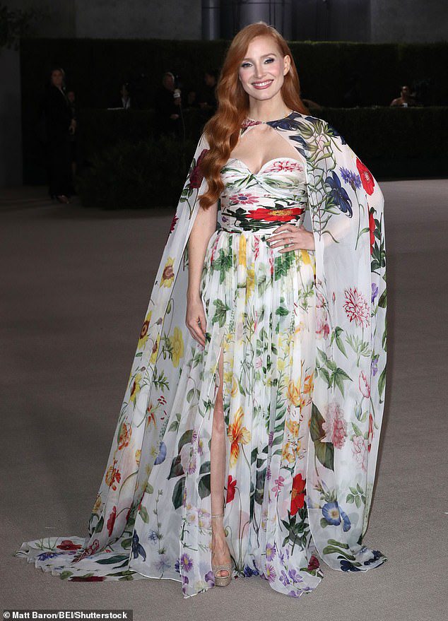 Flirty in Flowers: The Oscar-winner, 45, was a vision in a flowing white strapless gown with a vibrant floral pattern and a matching floor-length cape.