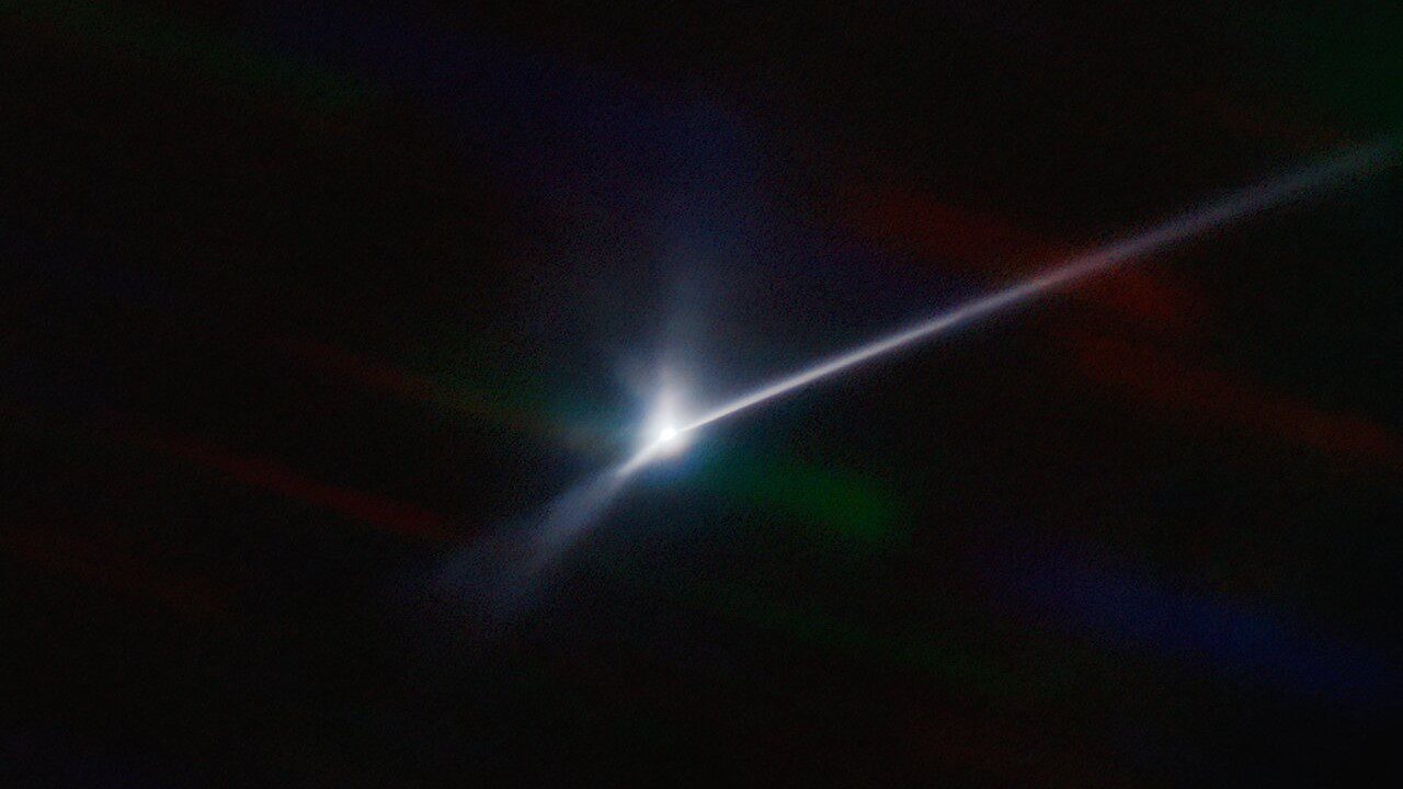 A bright spot with a long beam extending to the right