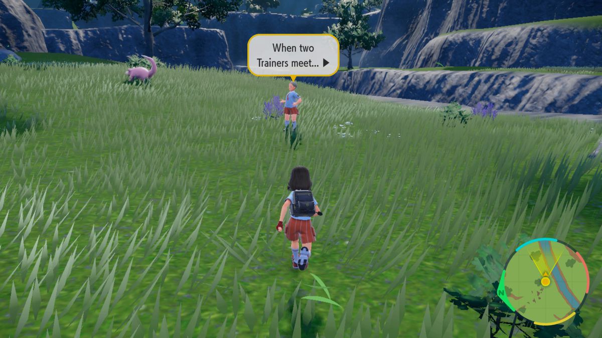 A Pokémon trainer runs towards another trainer in a grassy field