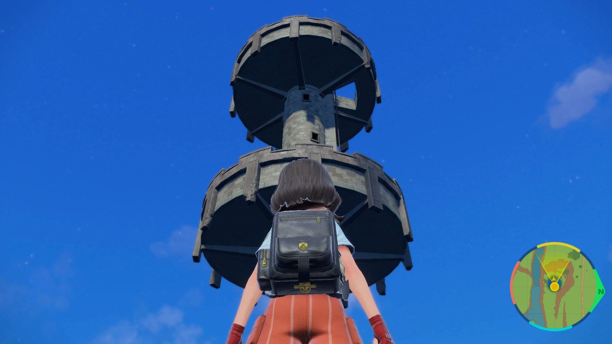 A Pokemon trainer stands in front of a huge watchtower