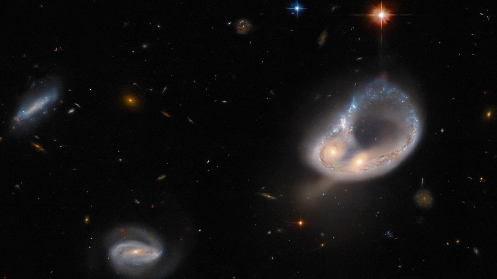This Hubble Space Telescope image shows merging galaxies 671 million light-years away
